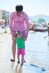 Image showing mom and baby on beach  have fun