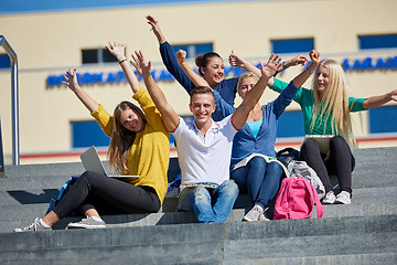 Image showing students outside sitting on steps