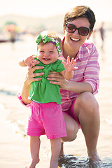 Image showing mom and baby on beach  have fun