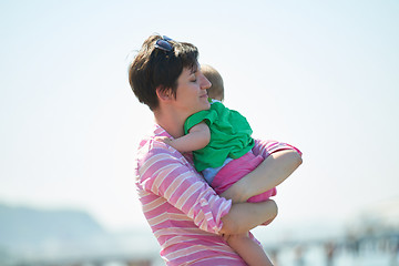 Image showing mom and baby on beach  have fun