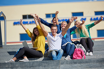 Image showing students outside sitting on steps