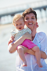 Image showing mom and baby on beach  have fun