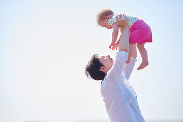 Image showing mom and baby on beach  have fun