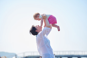 Image showing mom and baby on beach  have fun