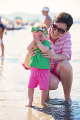 Image showing mom and baby on beach  have fun