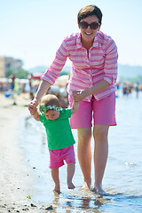 Image showing mom and baby on beach  have fun