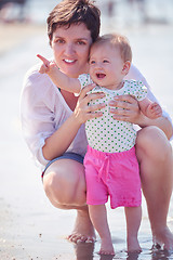 Image showing mom and baby on beach  have fun