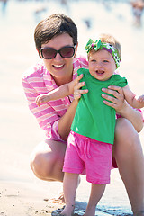 Image showing mom and baby on beach  have fun