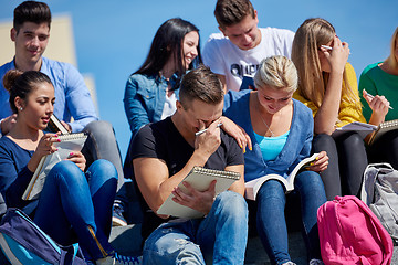 Image showing students outside sitting on steps