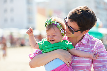 Image showing mom and baby on beach  have fun