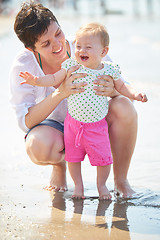 Image showing mom and baby on beach  have fun