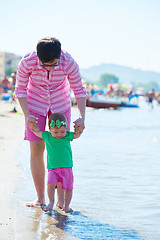 Image showing mom and baby on beach  have fun