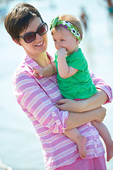 Image showing mom and baby on beach  have fun