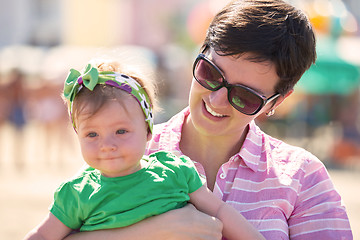 Image showing mom and baby on beach  have fun