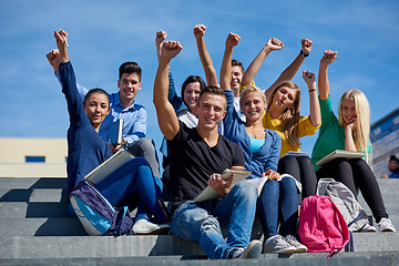 Image showing students outside sitting on steps