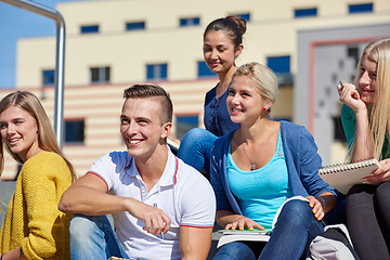 Image showing students outside sitting on steps