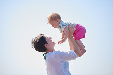 Image showing mom and baby on beach  have fun