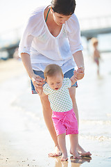 Image showing mom and baby on beach  have fun