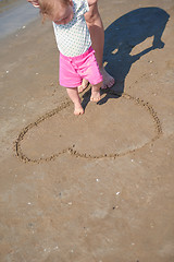 Image showing mom and baby on beach  have fun