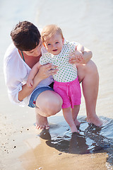 Image showing mom and baby on beach  have fun