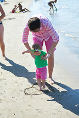 Image showing mom and baby on beach  have fun