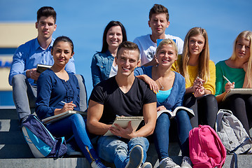 Image showing students outside sitting on steps