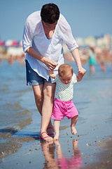 Image showing mom and baby on beach  have fun