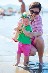 Image showing mom and baby on beach  have fun