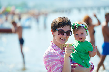 Image showing mom and baby on beach  have fun