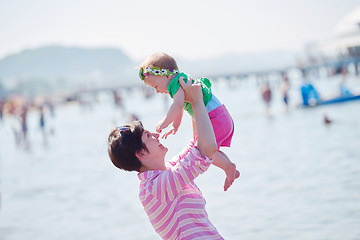 Image showing mom and baby on beach  have fun