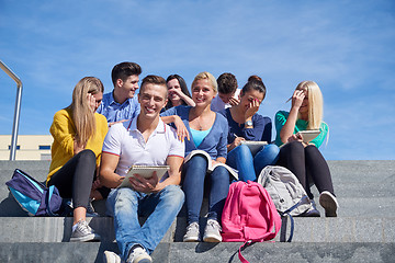 Image showing students outside sitting on steps