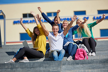 Image showing students outside sitting on steps