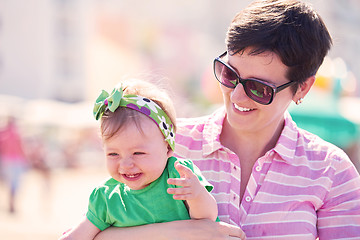 Image showing mom and baby on beach  have fun