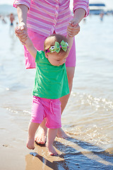 Image showing mom and baby on beach  have fun