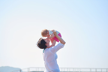 Image showing mom and baby on beach  have fun