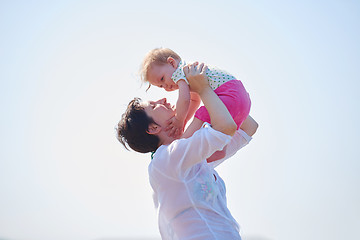 Image showing mom and baby on beach  have fun