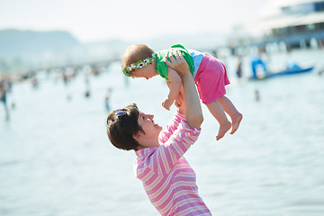 Image showing mom and baby on beach  have fun