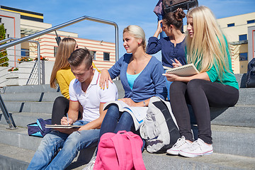 Image showing students outside sitting on steps