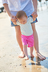 Image showing mom and baby on beach  have fun