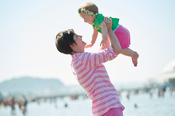 Image showing mom and baby on beach  have fun