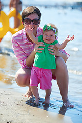 Image showing mom and baby on beach  have fun