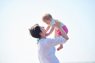 Image showing mom and baby on beach  have fun