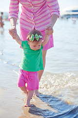 Image showing mom and baby on beach  have fun