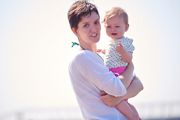 Image showing mom and baby on beach  have fun