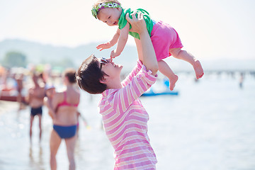 Image showing mom and baby on beach  have fun