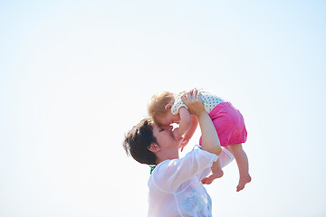 Image showing mom and baby on beach  have fun