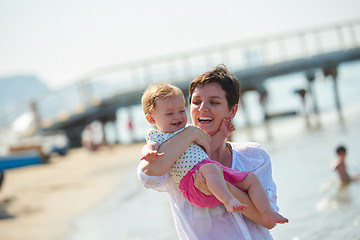 Image showing mom and baby on beach  have fun