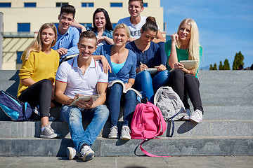 Image showing students outside sitting on steps