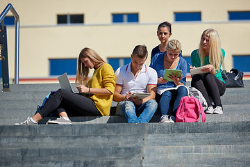 Image showing students outside sitting on steps