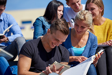 Image showing students outside sitting on steps